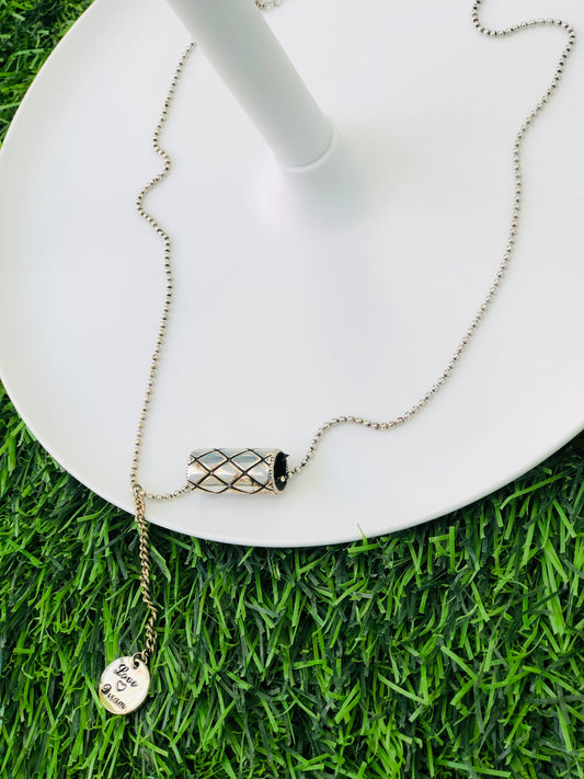 A long silver cylinder necklace and a medallion