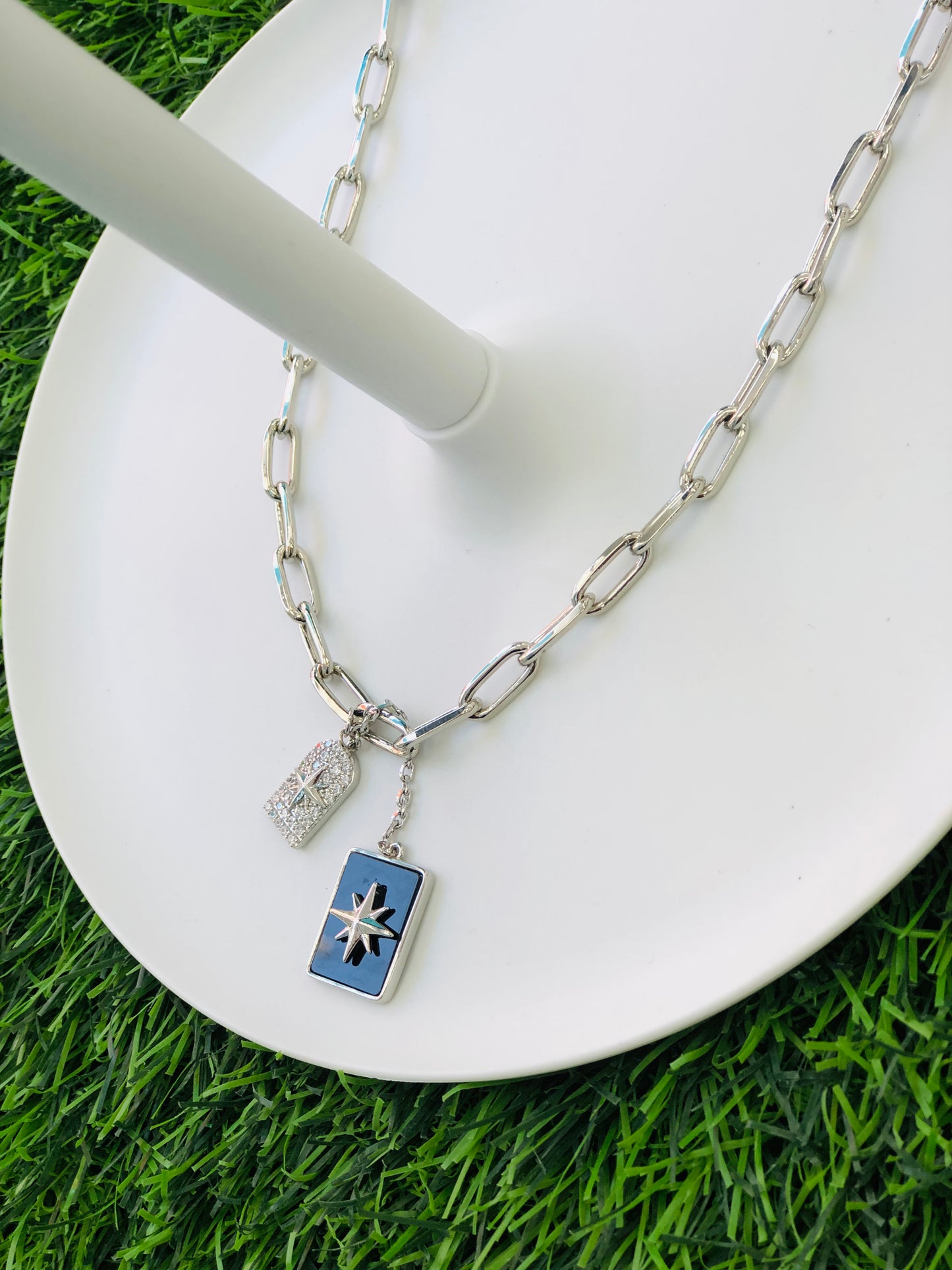 A long, rectangular necklace, black, gold and silver