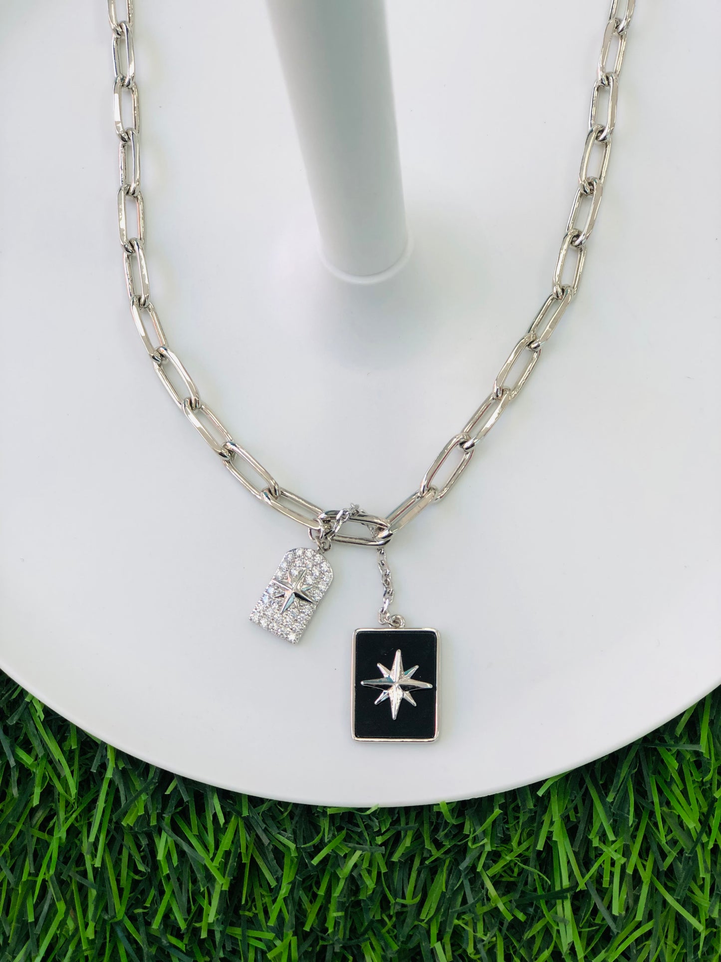 A long, rectangular necklace, black, gold and silver