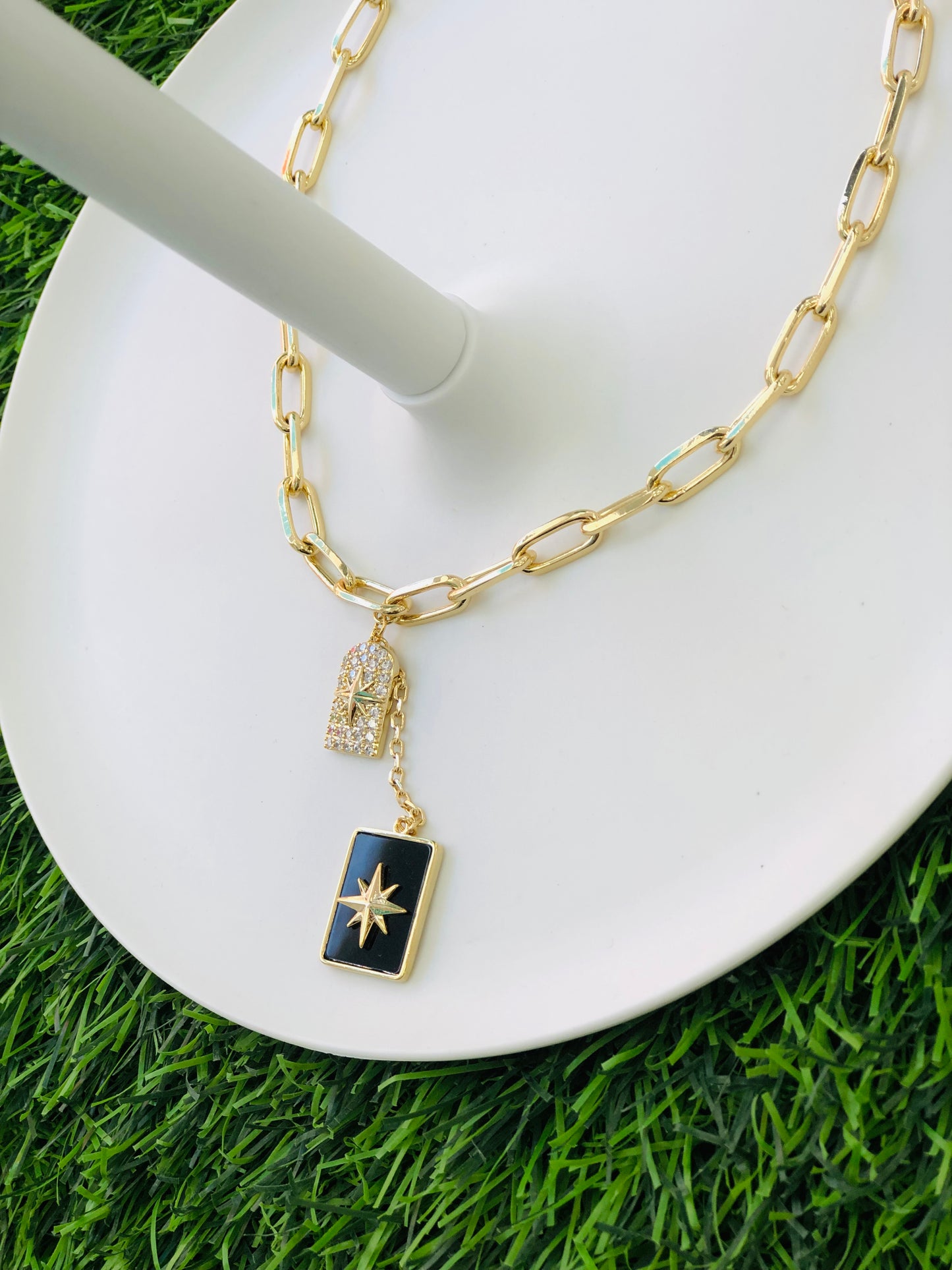 A long, rectangular necklace, black, gold and silver