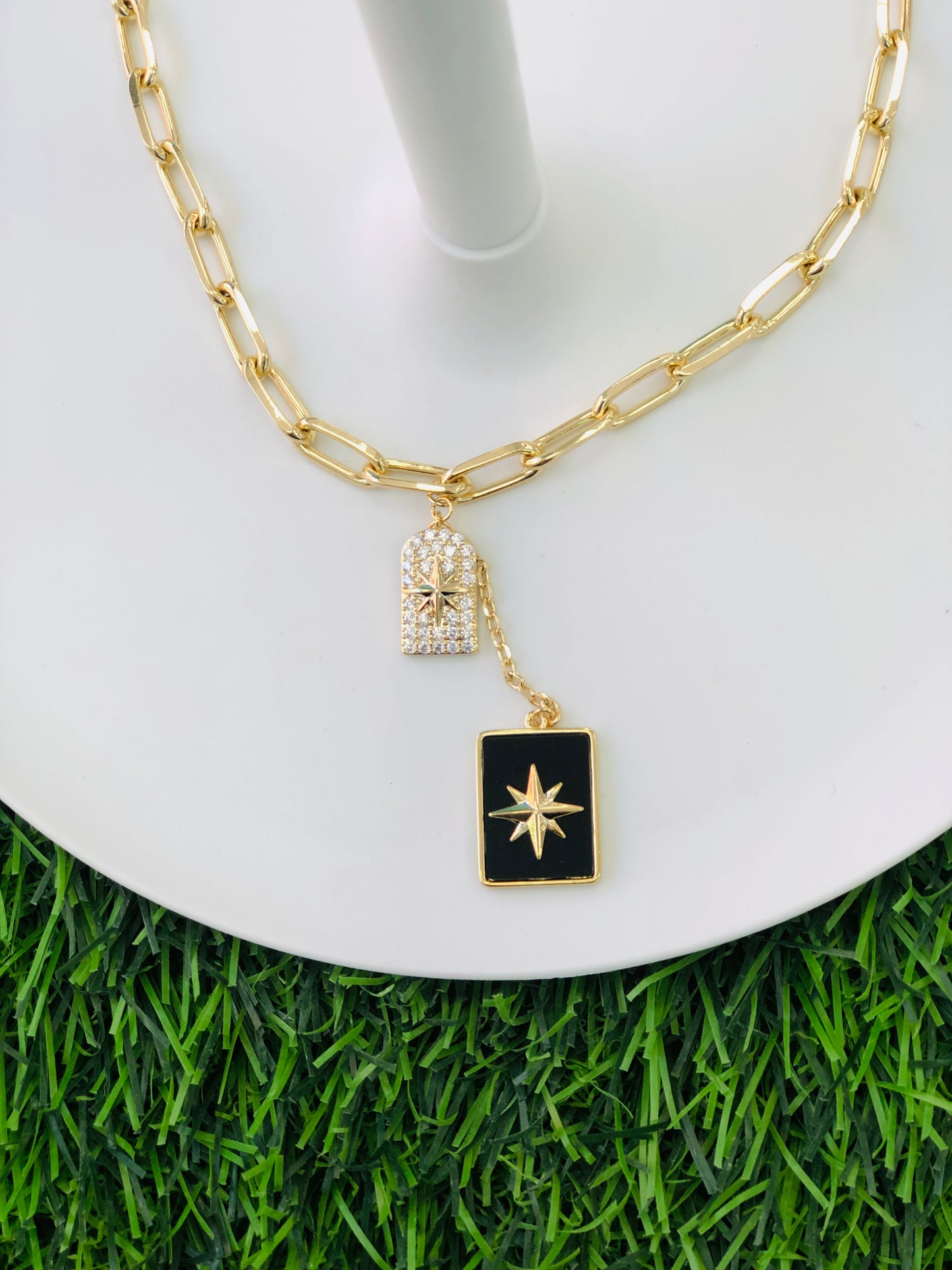 A long, rectangular necklace, black, gold and silver