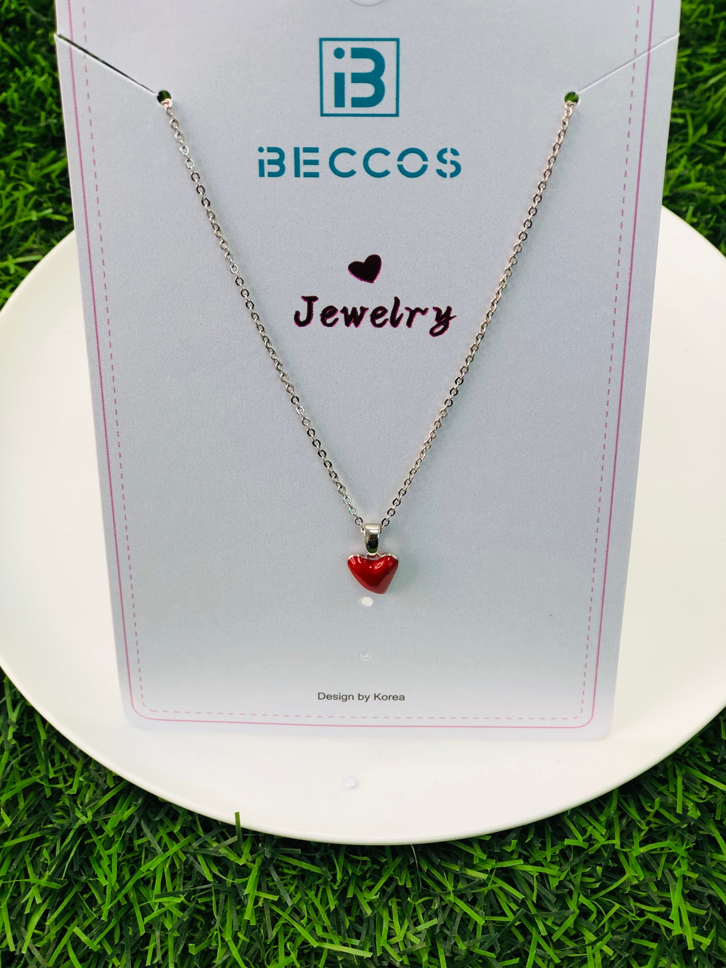 A long necklace with a gold and silver heart