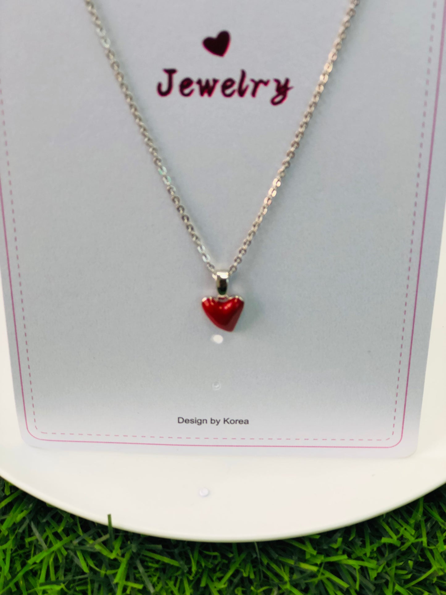 A long necklace with a gold and silver heart
