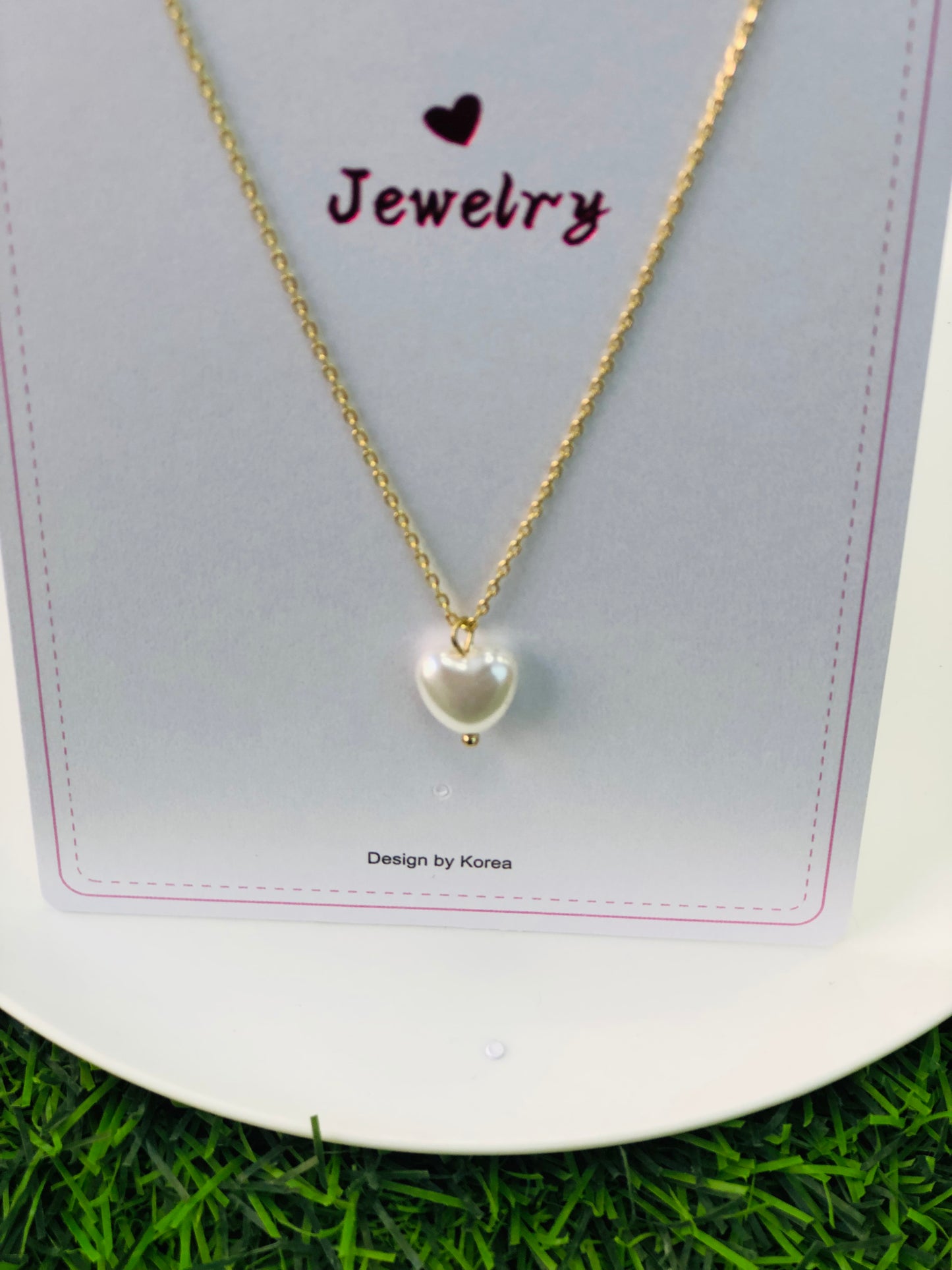 A long necklace with a gold and silver heart