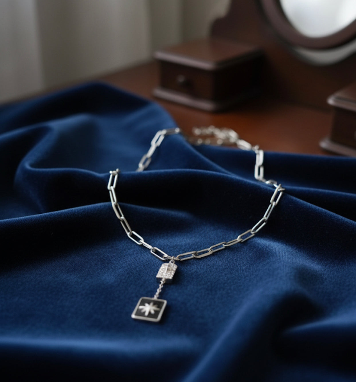 A long, rectangular necklace, black, gold and silver