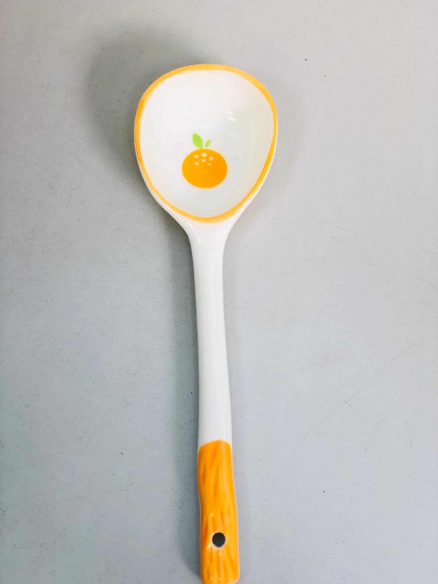 Orange ceramic spoon
