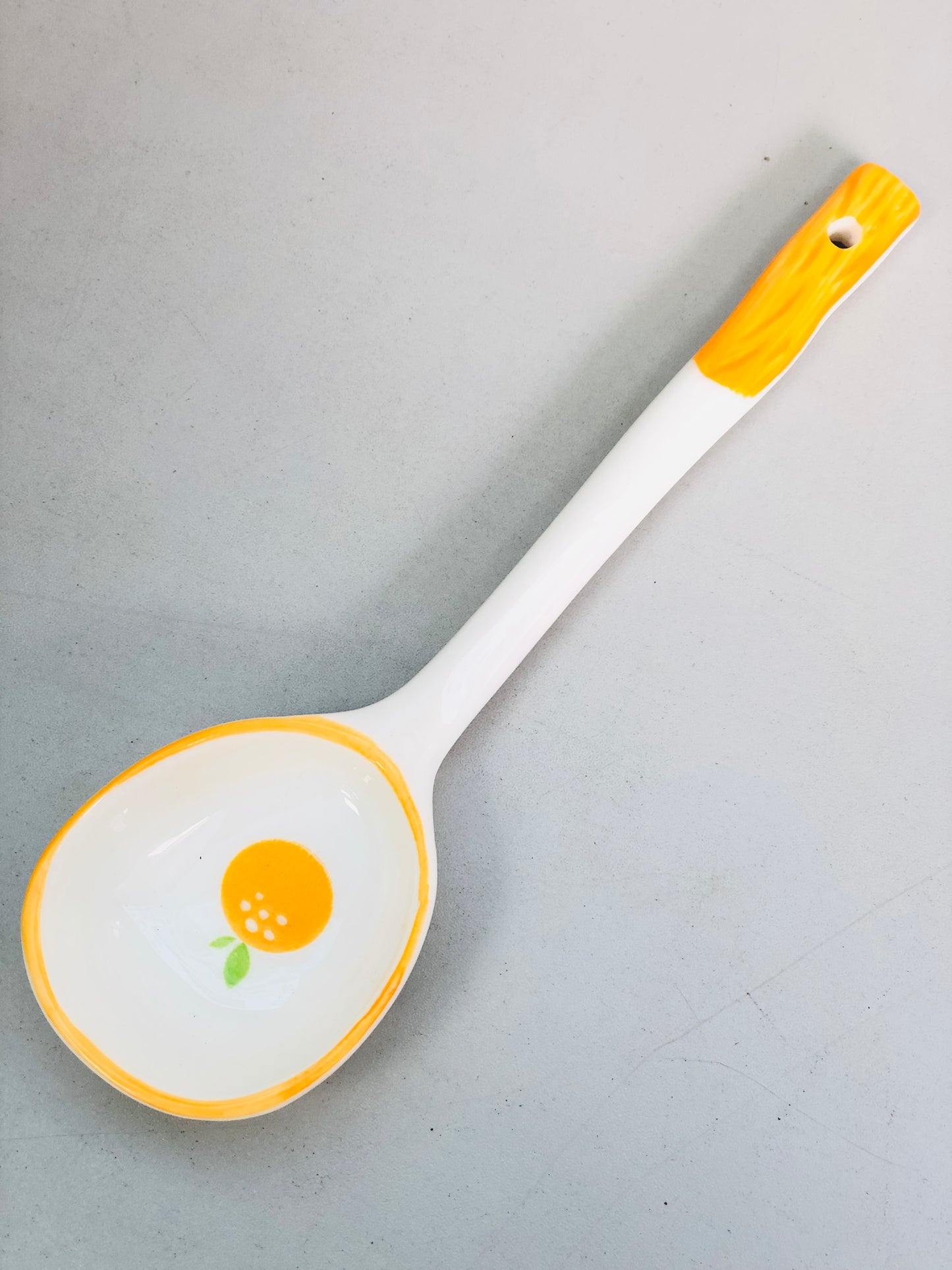 Orange ceramic spoon