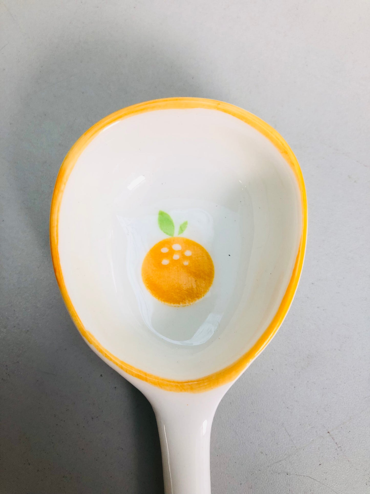 Orange ceramic spoon
