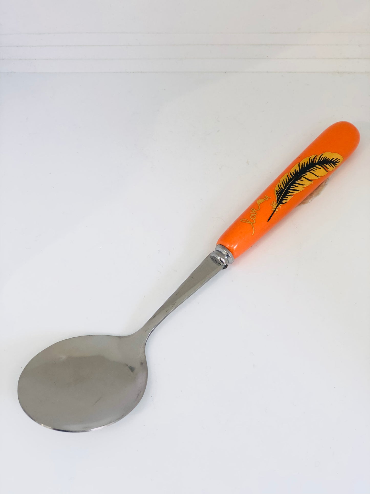 Orange ceramic spoon