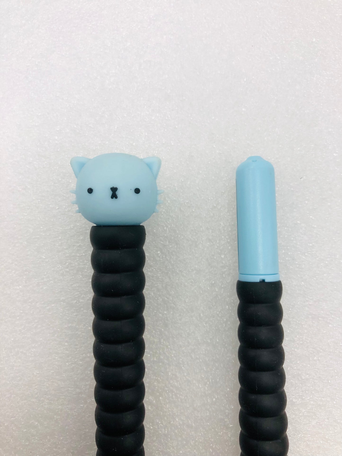 Black ink pen with blue cat head