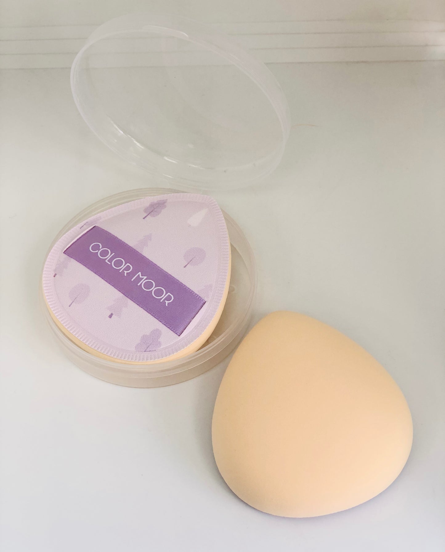 Purple oval makeup sponge with graphics