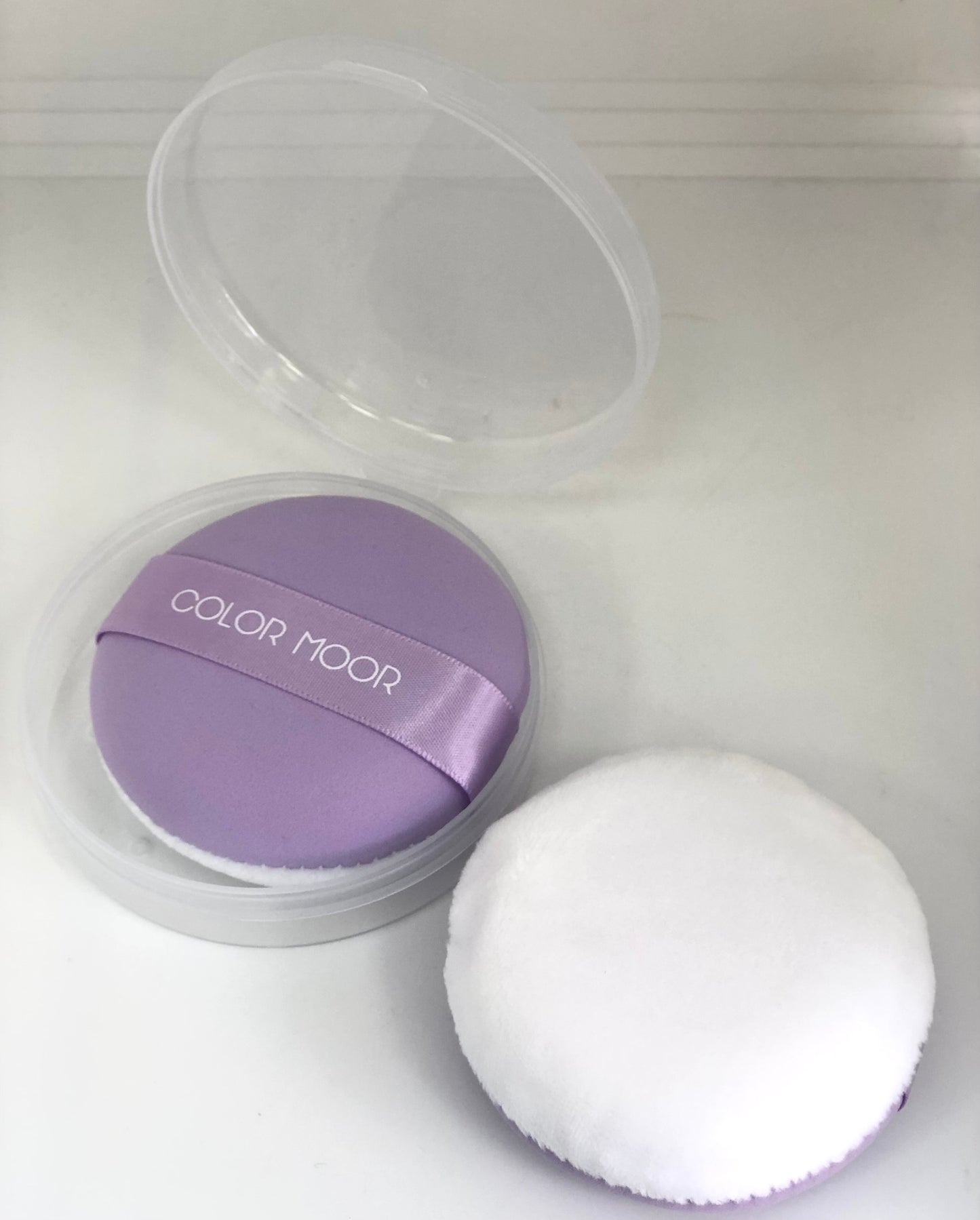 Round purple makeup sponge