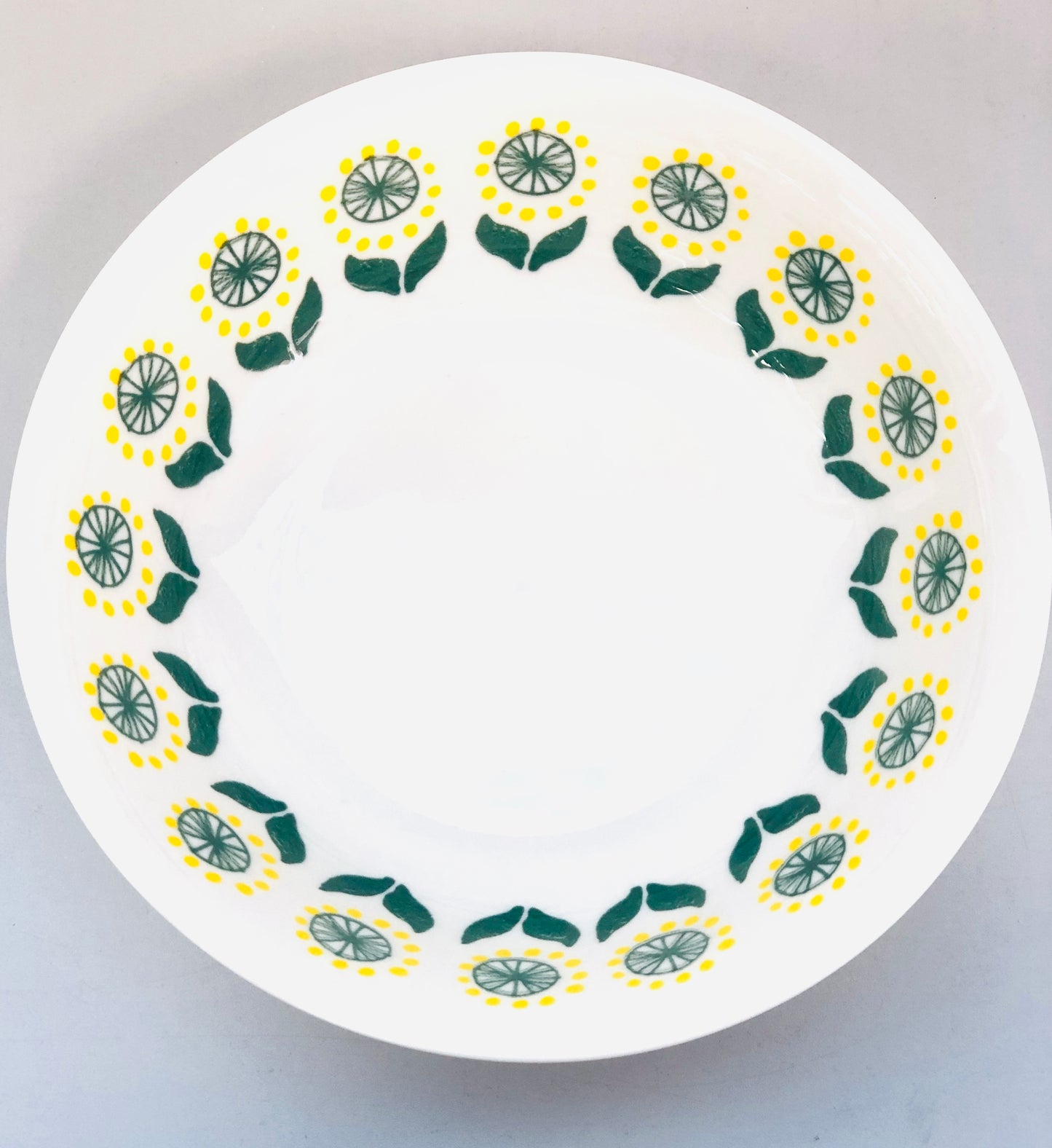 Ceramic dish with yellow and green pattern, 7 inches
