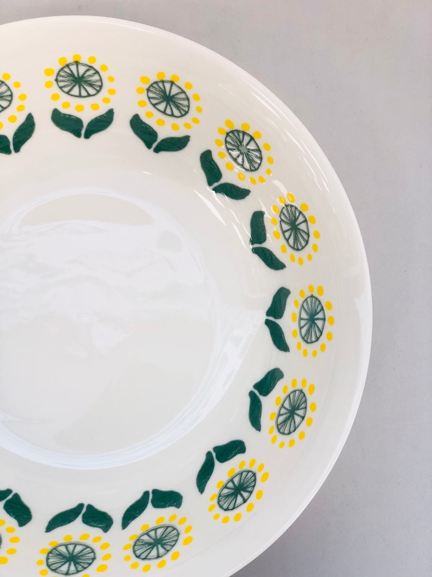 Ceramic dish with yellow and green pattern, 7 inches
