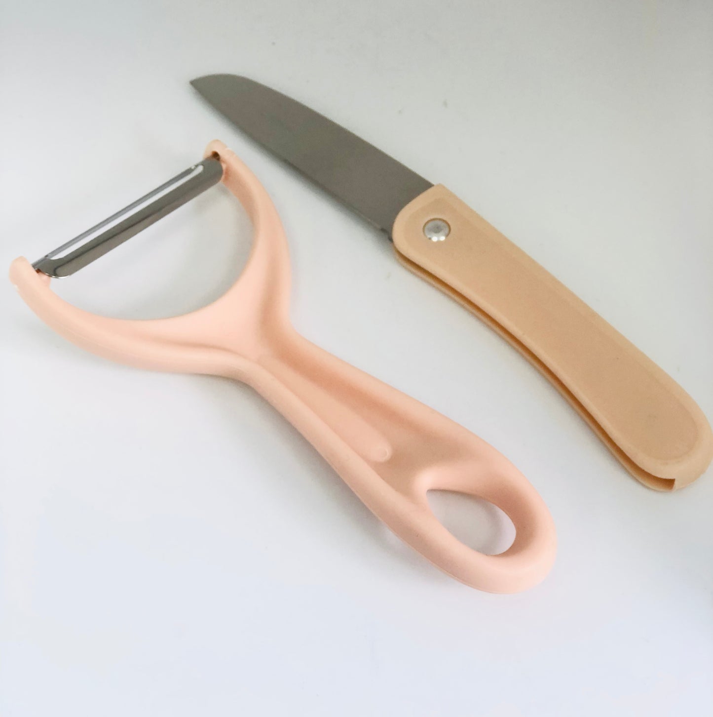 Food peeler with knife