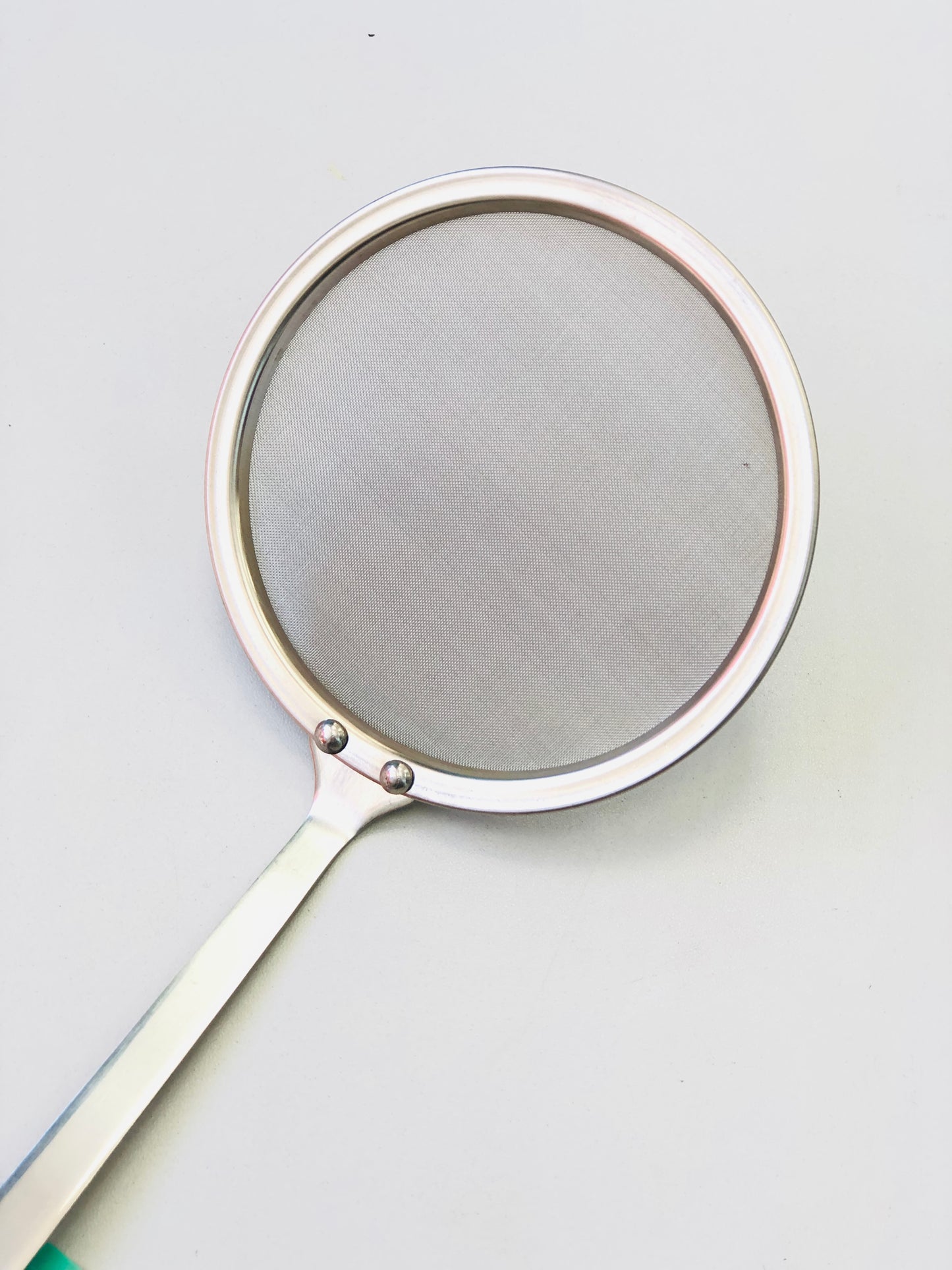 Circular stainless steel food strainer
