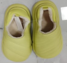 A winter footwear lined with green fur