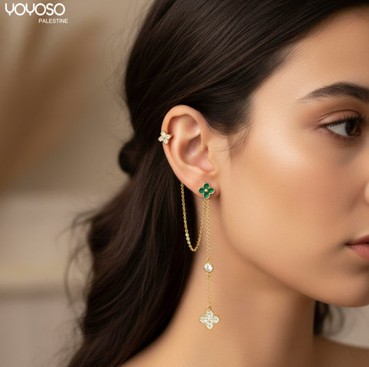 Long gold earrings wrapped around a rose