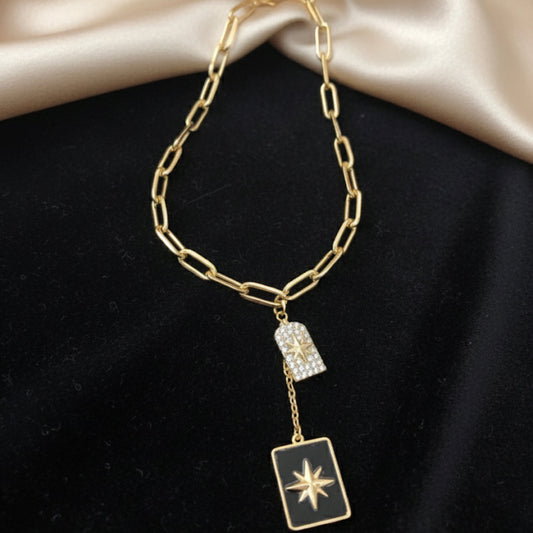 A long, rectangular necklace, black, gold and silver