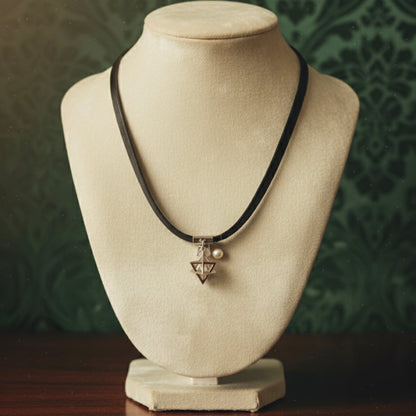 Short black leather necklace with a shaped medallion