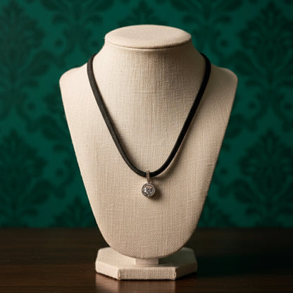 Short black leather necklace with a shaped medallion