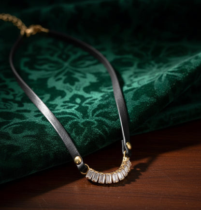 Short black leather necklace with a shaped medallion