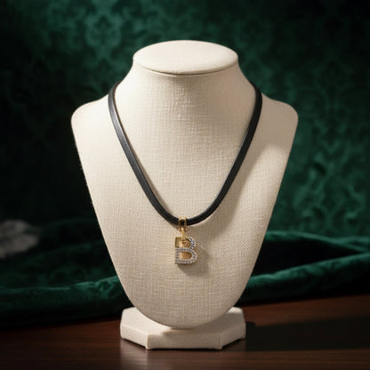 Short black leather necklace with a shaped medallion