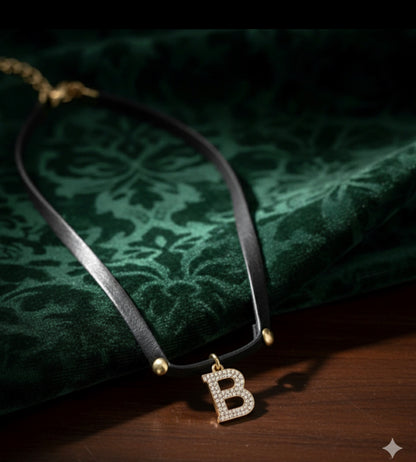 Short black leather necklace with a shaped medallion