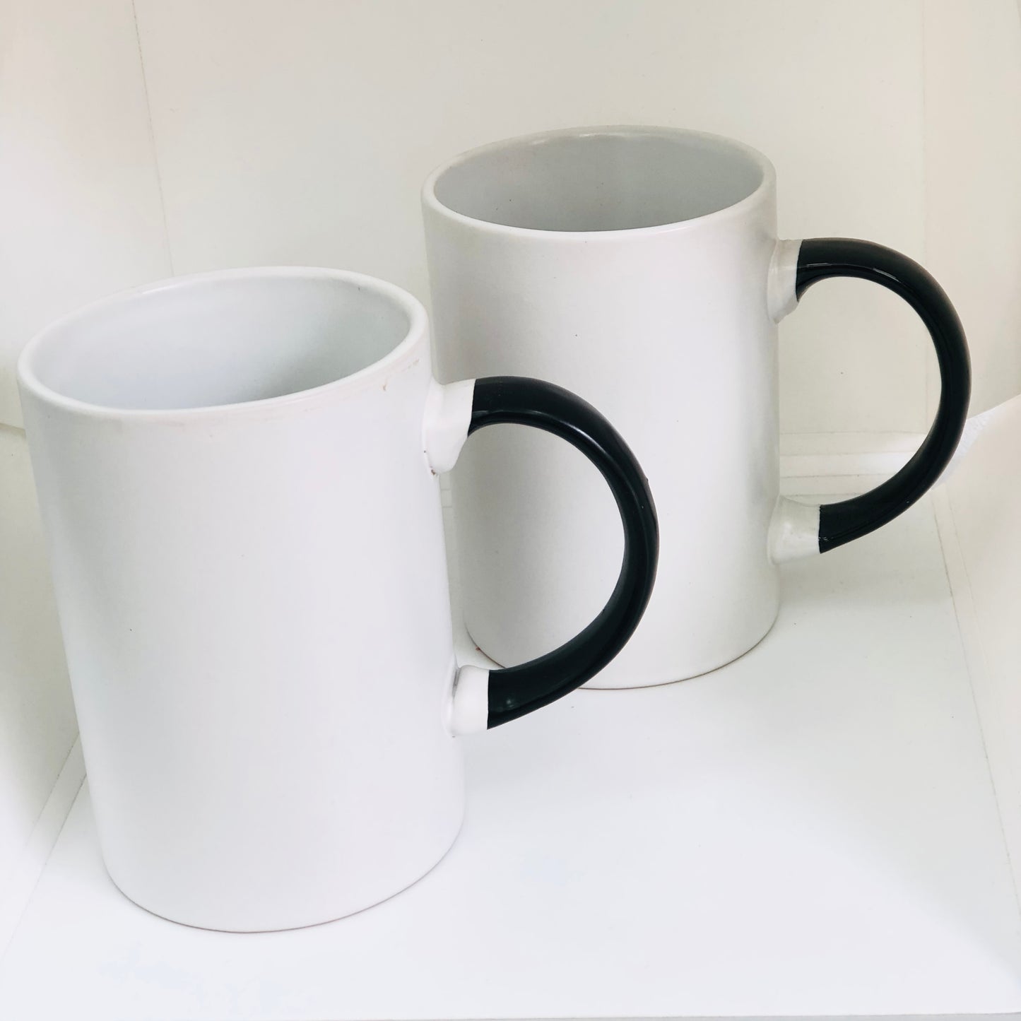 White ceramic mug with black handle