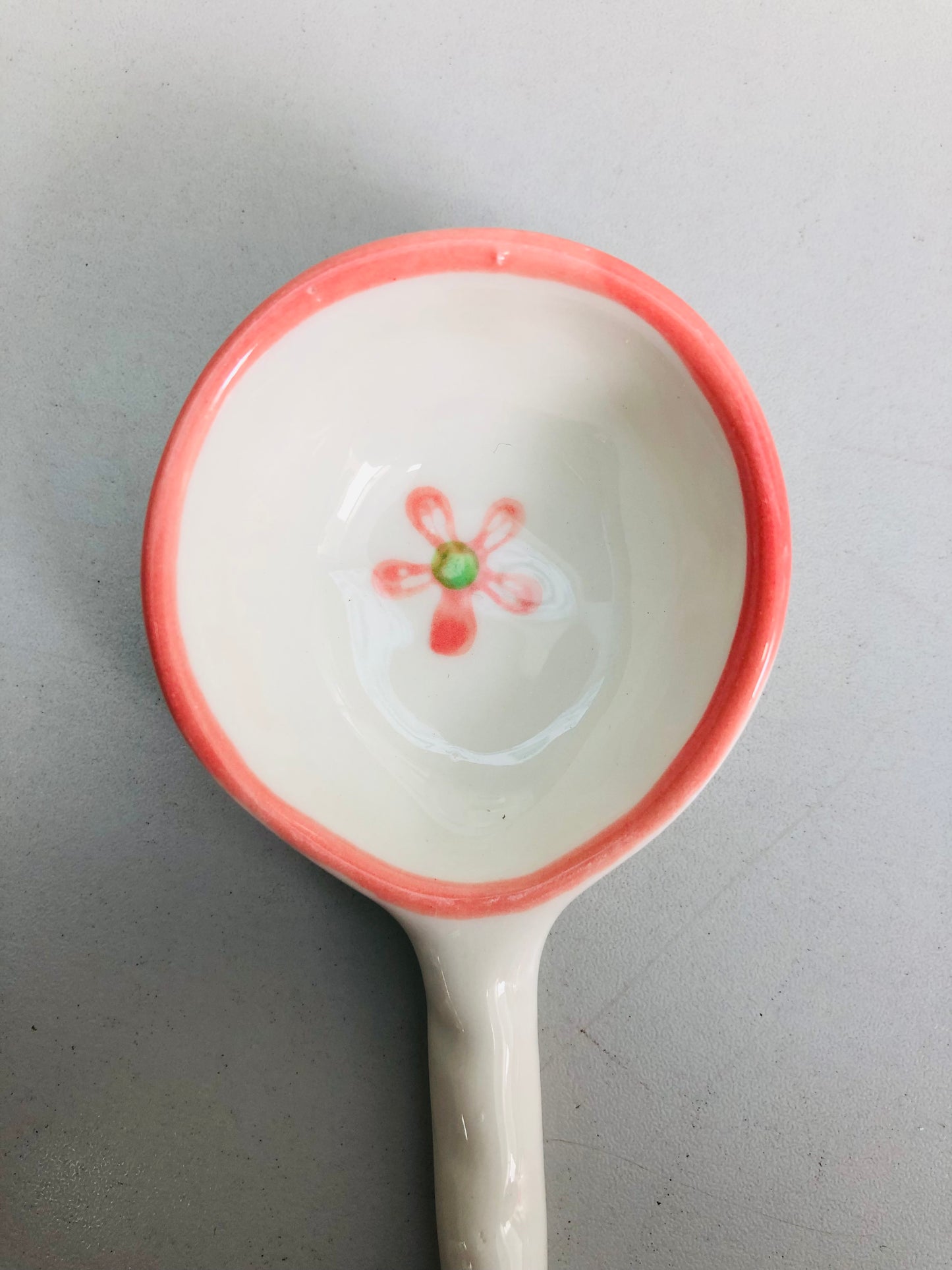 White and pink ceramic pendant with a rose