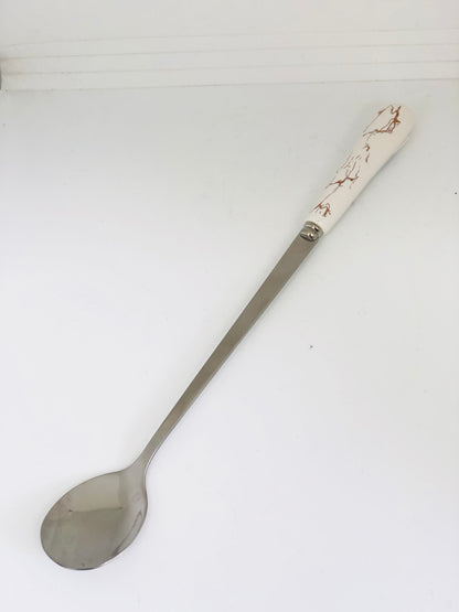 A set of white and gold ceramic spoons and forks